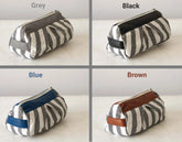 Four zebra-striped pouches in different color options on a light background
