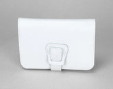 White leather wallet with a buckle on a gray background