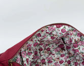 Floral-patterned interior of a red bag on a white background