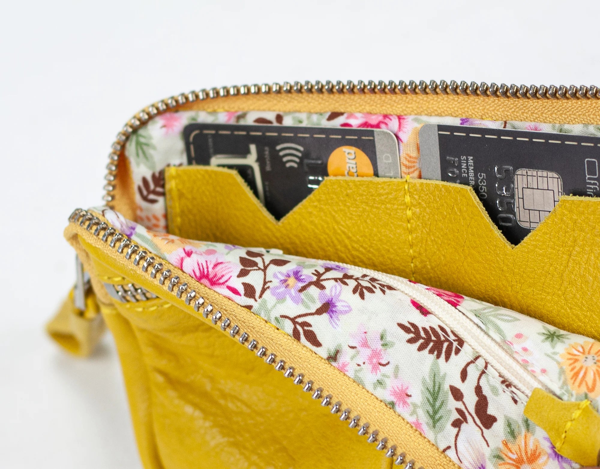 Yellow wallet with floral interior showing credit cards