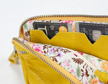 Yellow wallet with floral interior showing credit cards